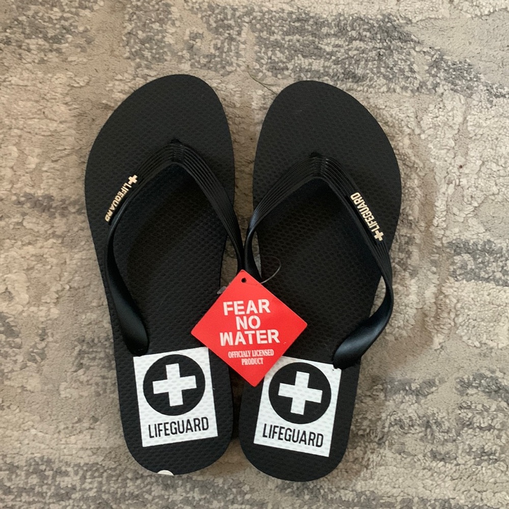 Never worn before, black lifeguard flip flops!!